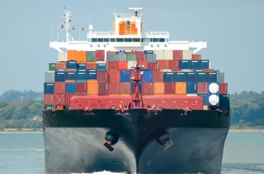 fully loaded container ship head-on in calm water